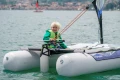 Żeglowanie katamaranem Minicat Guppy - widok z tyłu - chłopie w kamizelce za sterem.
